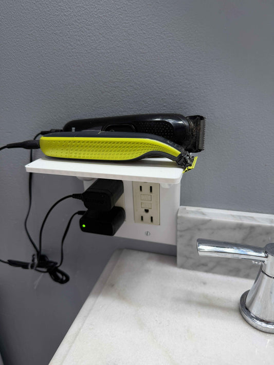 Double outlet shelf in white with a device plugged in