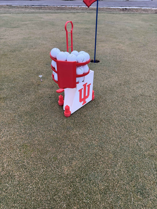 Indiana Hoosiers golf ball dispenser on artificial turf, angled view