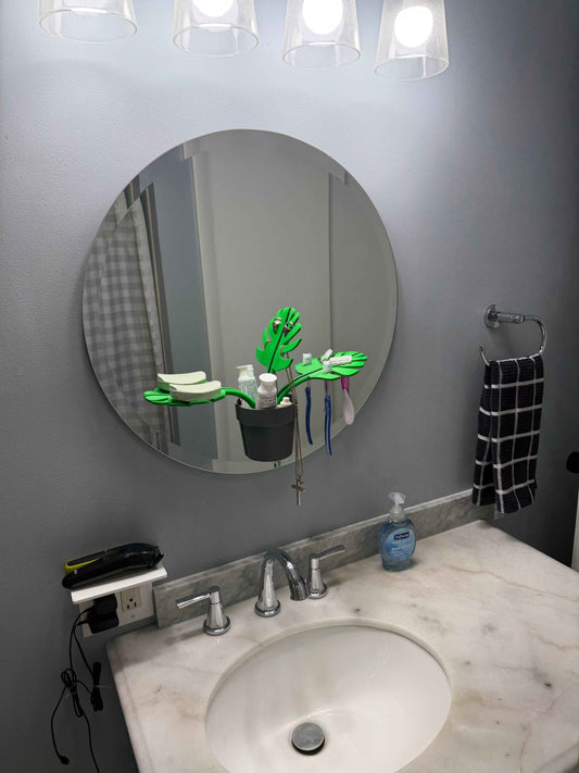 Monstera leaf mirror mount bathroom organizer on a bathroom mirror above a sink