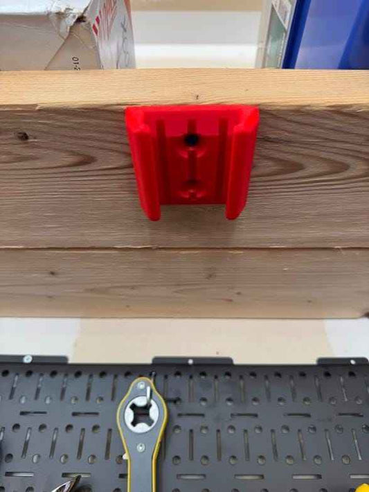 Craftsman V20 battery mount in red on a wall with a battery