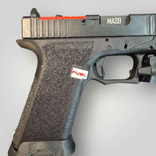 FUEL extended magazine release in red installed on a pistol